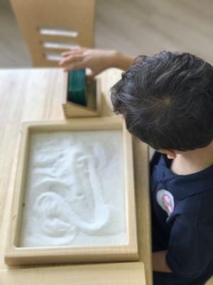 Using sandpaper numbers and a sand tray to practice our writing skills!