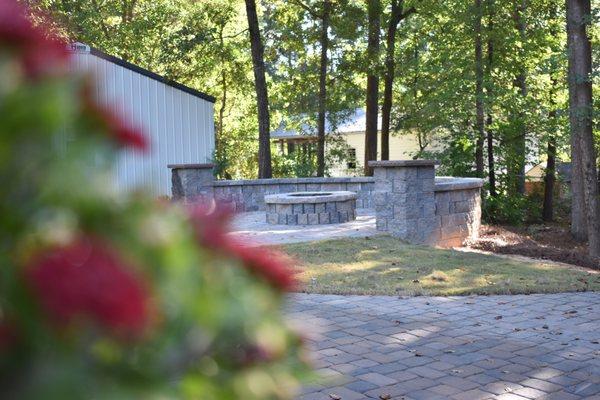 Outdoor stone and paver fire pit in backyard paradise by Saluda Hill Landscapes in Lexington SC