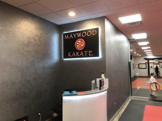 Front desk area and back-lit Maywood karate sign.