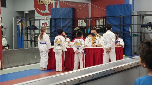 My son getting critiqued after his test advancing to the next belt.