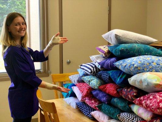 Volunteers make pillow for patients who have c-sections or stomach surgeries that provide comfort.