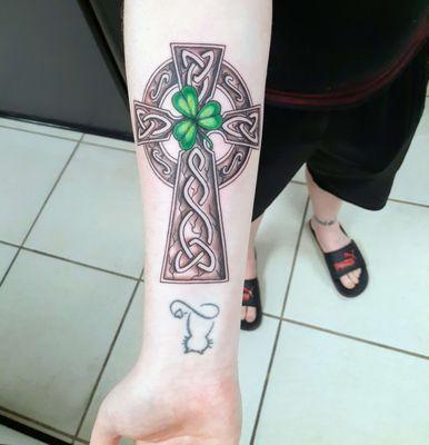 Celtic cross with a green clover