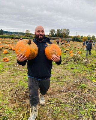 My man carrying the pumpkins because I forgot the wagon!