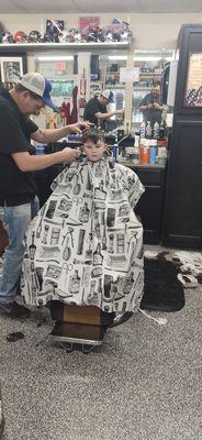 My son getting his hair cut. He loves Macs!