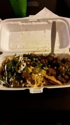 Fye! Jerk Chicken Nachos. Traditional tortilla chips, nacho cheese, cilantro, jalapeño peppers, drizzled with sour cream