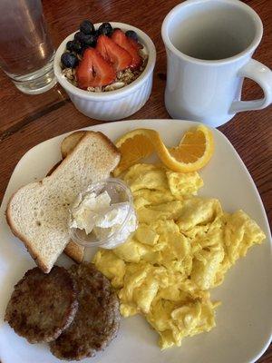 Sausage patties and eggs with a side of yogurt parfait.