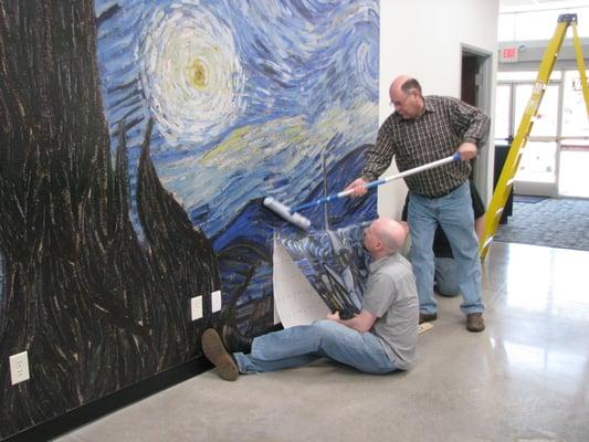 Installing Van Gogh's "Starry Night" on a wall in our shop. This is a removable vinyl wall graphic.