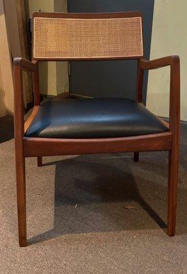 A teak Risom chair with a new leather seat.