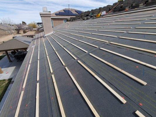 New underlayment installation, flat tile reinstallation, Lancaster, CA.