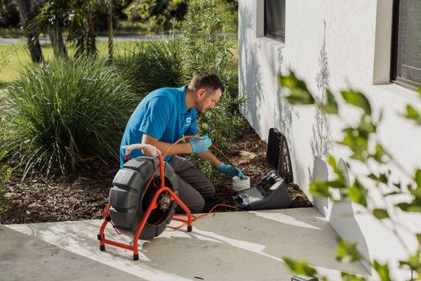 Performing a video inspection of sewer drain pipe to find out if there are any issues with it