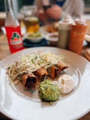 Happy hour carnitas taquitos dorados & a fruit punch