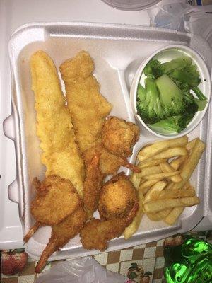 fish and shrimp dinner with steamed broccoli and fries complimentary hush puppies