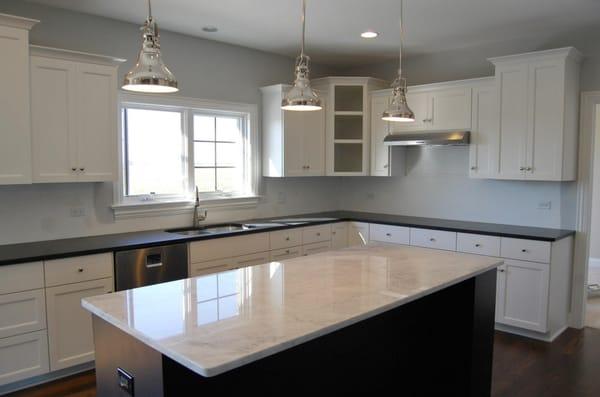 3cm Black Absulote Honed Granite on Kitchen Perimeter with 3cm Bianco Carrara Polished Marble Island.