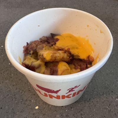 Dunkin' Donuts dinky yet tasty Loaded Hash Browns portion with Queso and Bacon