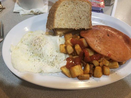 Over easy eggs, bologna, home fries and rye toast