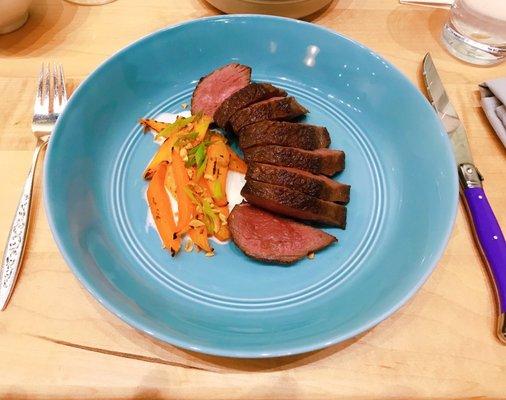 Steak, roasted carrots, peanuts.