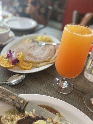 Delicious pancakes with powder sugar and mimosa