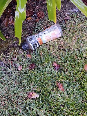 RSI workers juice bottle left in grass.