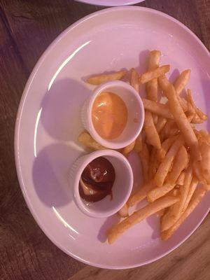 French Fries with a spicy sauce and ketchup