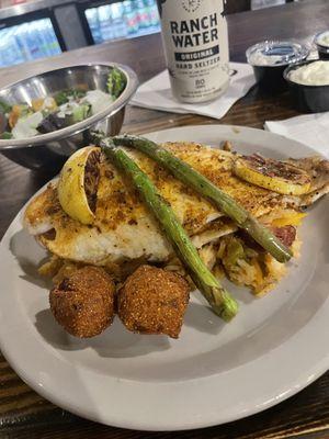 Blackened fish on a FANTASTIC Cajun rice. Those hush puppies are yum!