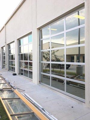 Full view aluminum commercial garage doors.