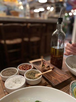 Chili oil, hot pepper flakes, oregano, salt and pepper