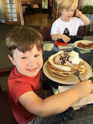 Massive chocolate chip pancakes with a whip cream smiley face! Happy happy boy!