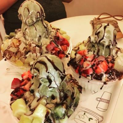 Patbingsoo with fruit, condensed milk, red bean, green tea ice cream, & chocolate drizzle. Small (foreground) and large (background) sizes.