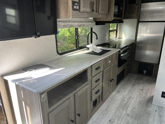 Roughly ten feet of counter with under cabinet lighting with five sets of outlets.