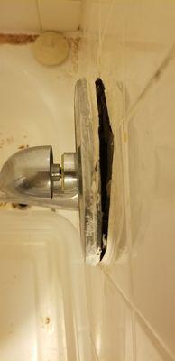 This is after they pulled the faucet out, left a dripping hole in the wall for weeks, and then just stuck the faucet back on.