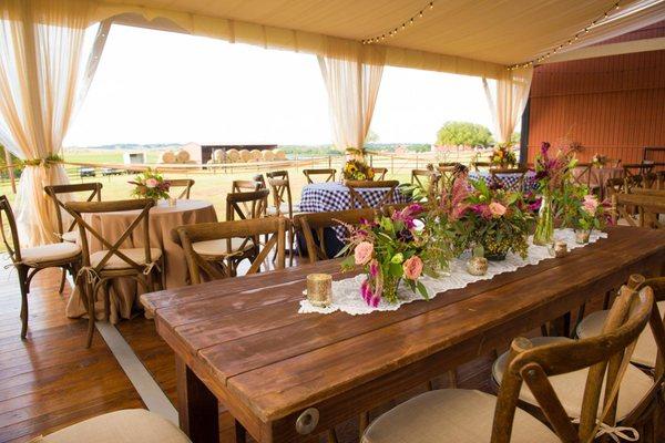 Farm Table rentals in a pole tent for a wedding.