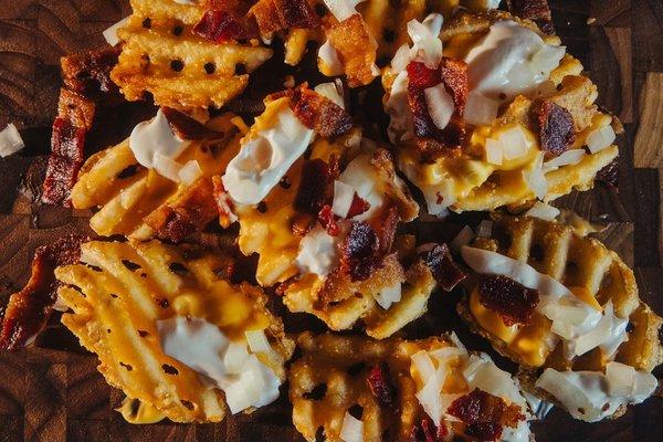 Potato Skin fries, waffle fries, topped with cheese, onion, bacon and sour cream