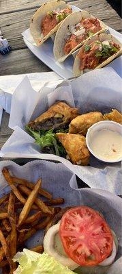 Top to bottom: shrimp tacos, philly cheesesteak egg rolls, cheeseburger w/ fries