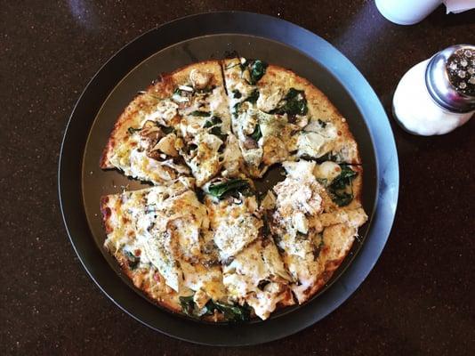 Gluten free thin crust with olive oil base, chicken, mushroom, artichoke, spinach, oregano, and cheddar