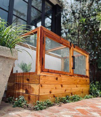 Billie wanted herbs outside his kitchen window. 
 He's an interior designer, so it had to look super sexy. 
 RH door handles topped it off.