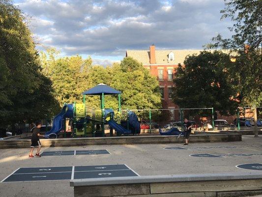 Little kid side of the playground + swings + hopscotch