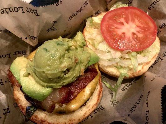 Dollar burger on Tuesday. Burger topped with avocado, guacamole, bacon, lettuce, tomatoes, and cheese