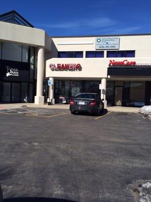 Storefront of strip mall Three Oaks Plaza