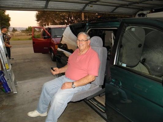 Client being lifted into MiniVan with Turning Automotive Seat