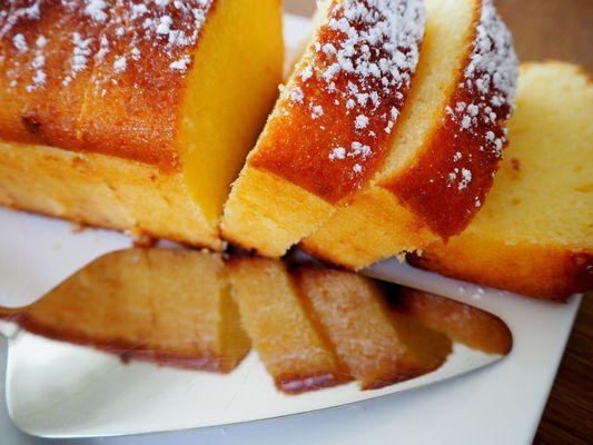 Our lemon pound cake loaf, sliced & topped with confection sugar..