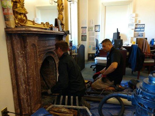 Sweeping a fireplace at the US Capitol.