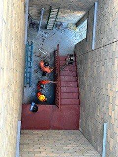 Our crew installing primer-painted stairs