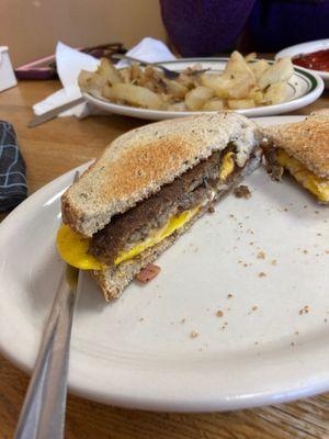 Scrapple eggs and cheese on rye and home fries.