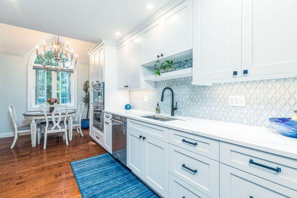 A bright white galley kitchen.