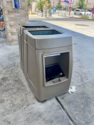 Trash bins and windshield squeegees provided at each pump