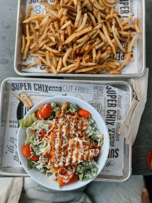 A picture of the Nashville Hot Salad and A large order of fries