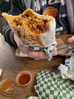 Al Pastor burrito with rice, beans, meat and cheese. The al pastor had a bit of pineapple in it. Mmmm.