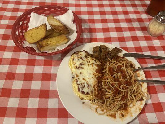 Half Spaghetti & meatballs half Ravioli with meat sauce. Garlic bread comes with meal.