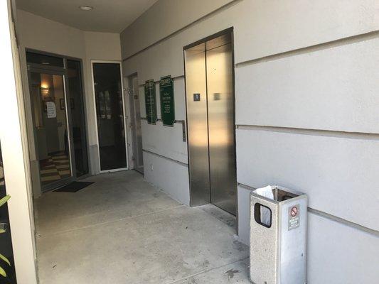 Distance from the curb to the elevator. Elevator opens into waiting room on second floor.