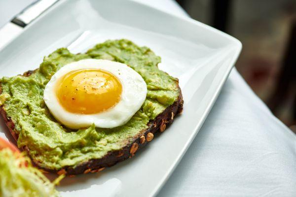 Avocado Toast - grilled sourdough, soft poached eggs, sprouts, radish, salad